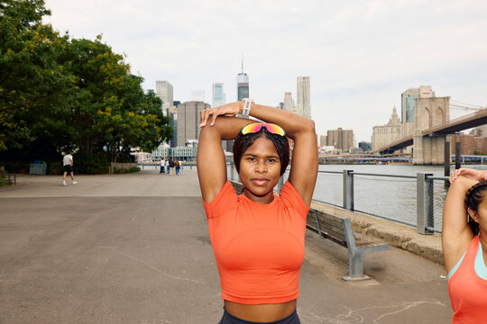 Women warming up their arms at the waterfront