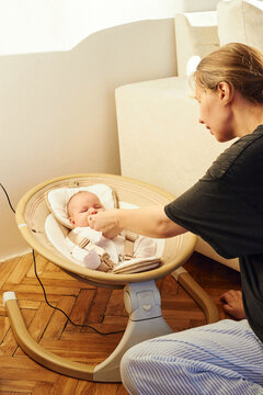 Mother gives her baby a pacifier