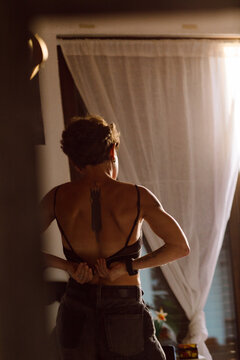 a young woman getting dressed