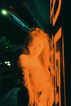 Cinematic Night Portrait of Young Woman Bathed in red Light