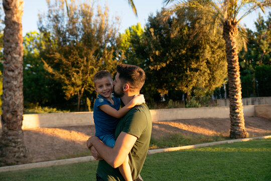 Dad hugging his son