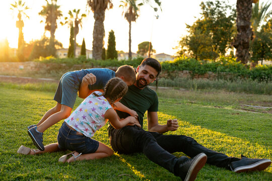 Children having fun with their father