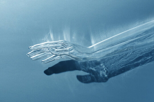 Transparent plastic hand on blue background