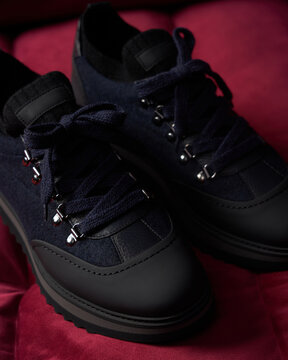 Shoes on a red surface with dark background