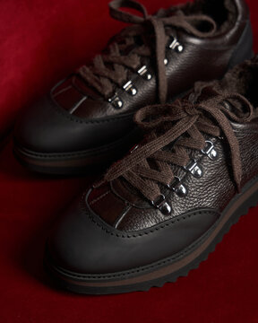  Close-up of brown leather hiking sneakers with a rugged design 