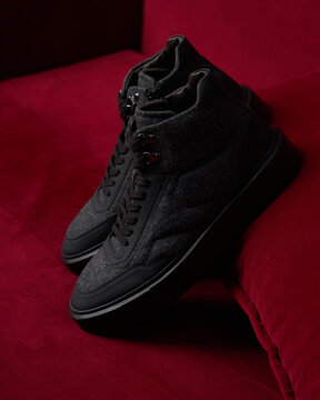 Shoe display on a red surface in indoor setting