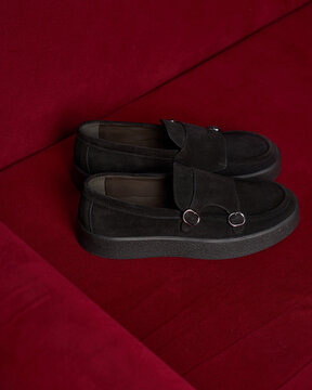 Black shoes on a red surface in a casual setting
