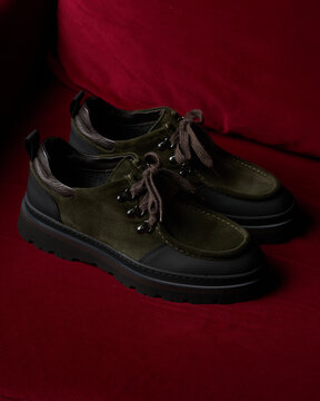 Stylish shoes on a red background in a bright setting