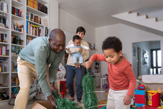 Family unboxing Christmas Tree for Holiday 