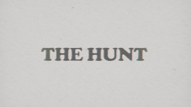 CMYK Halftone Text The Hunt Printed on Changing Paper with Vintage Stop Motion Effect.