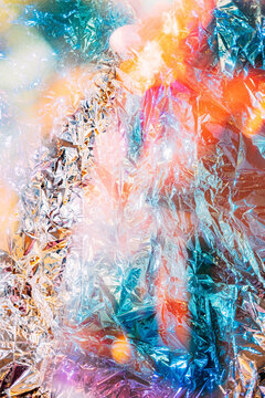 Light reflects on shiny foil in vibrant colors