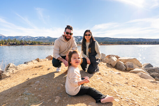 family having fun by lake 