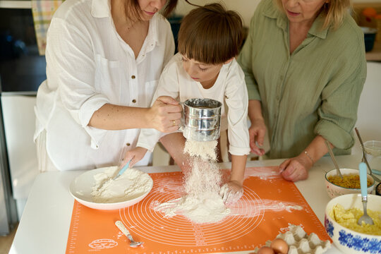 Child Baking with Mother and Grandmother