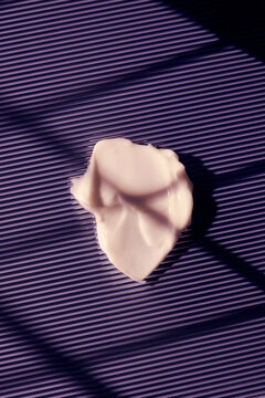 skincare lotion smear over purple background
