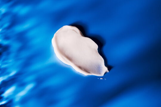 skincare lotion smear over blue background
