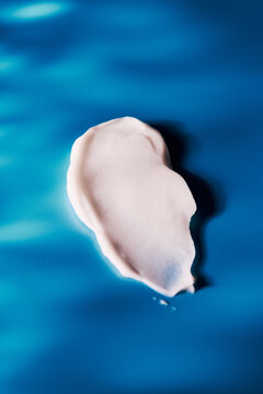 skincare lotion smear over blue background