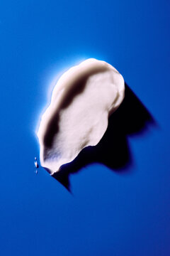 skincare lotion smear over blue background