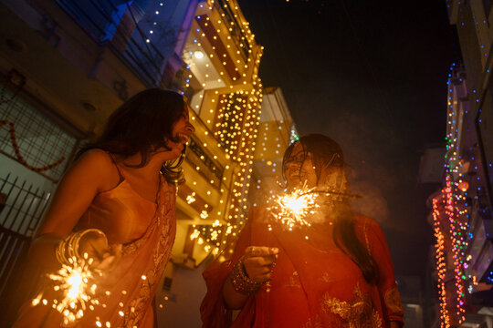 Women Celebrate Festival With Sparklers During Night Time