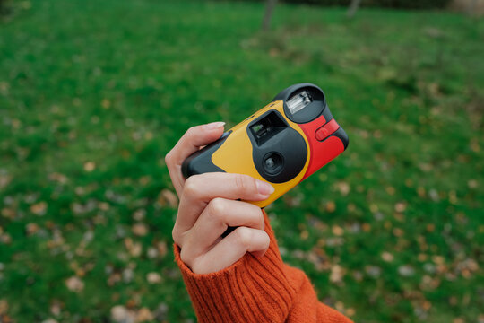 Hand Holding Disposable Camera