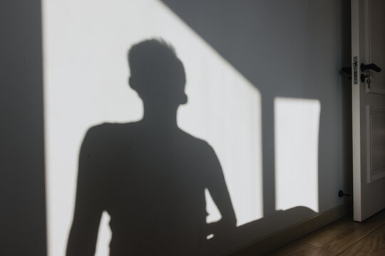 Silhouette of Person on Sunlit Interior Wall