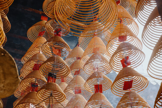 Overhead View of Hanging Spiral Incense Coils with Red Prayer Tags