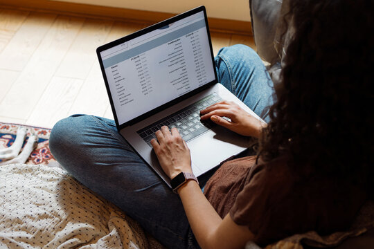 Woman Working on Laptop at Home on Floor