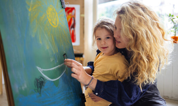 Mother and Child Painting Together in Art Class