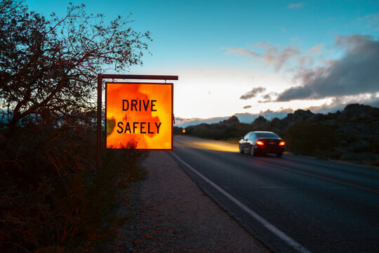 Drive safely on open road at dusk
