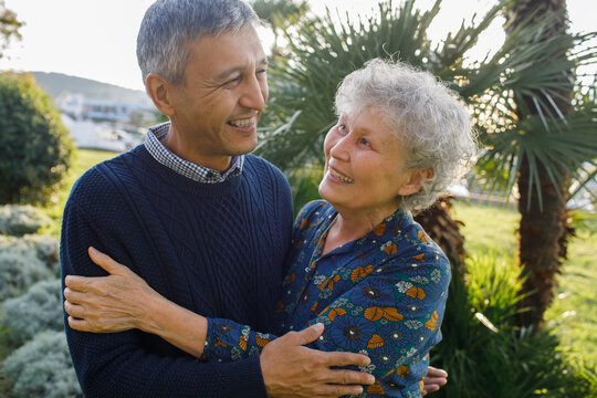 Laughing old mother and her adult son in the park