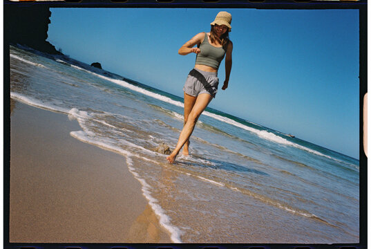 walking on water beach tourist smiling on vacation kauai Napali Coast
