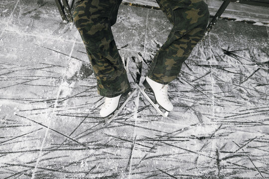 Legs of girl, weared in white ice skates