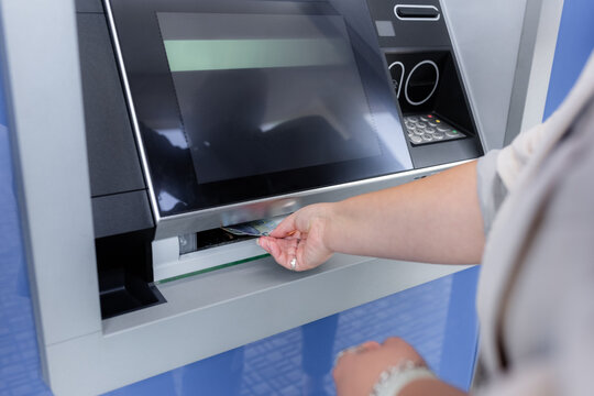Plus size woman withdrawing cash from ATM 