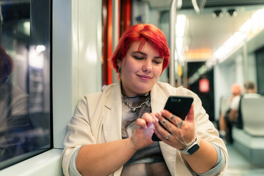 Woman Uses Smartphone on Public Transport During Afternoon Commute