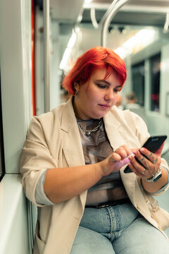 Woman With Red Hair Uses Phone on Train 