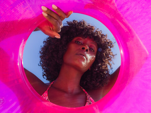 Woman Looking Through a Float at a Sunny Beach Scene