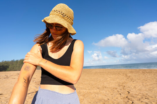applying sunscreen to arm 
