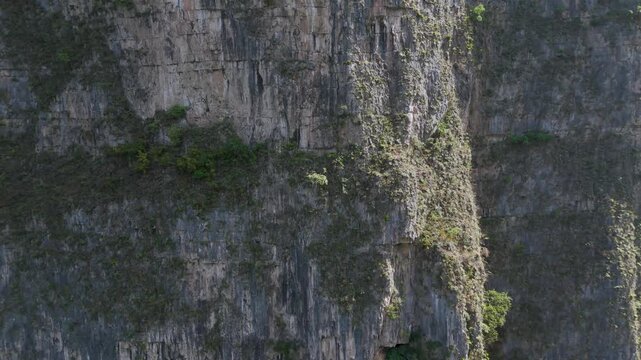 Iconic "&Aacute;rbol de Navidad" (Christmas Tree) moss-covered rock formation with water trickling down into the Sumidero Canyon at Grijalva River, Chiapas. Mexico.