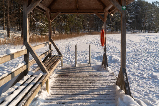 Snowy Dock Near a Frozen Lake During Winter Morning