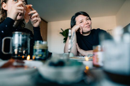 A Couple Shares Snacks and Drinks in a Cozy Indoor Space