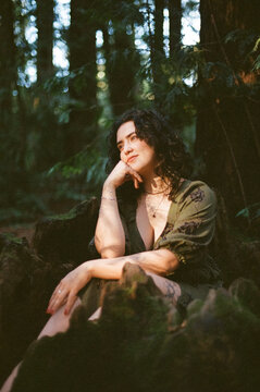 Woman Sitting in Hollowed Tree Stump