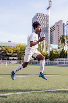 Soccer player jumping during warmups