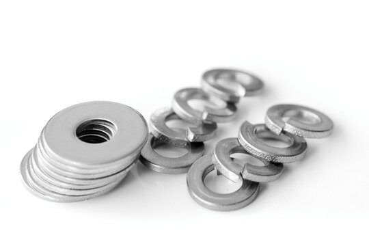 Metal flat and grover washers on white background