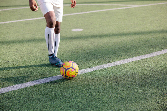 Soccer player positioning ball on field