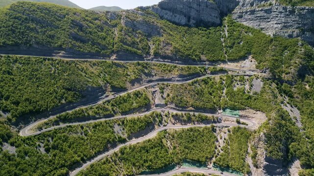 Aerial view of the winding SH20 road in the Albanian Alps with dramatic mountain serpentines and scenic hairpins at Leqet e Hotit pass