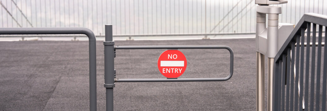 Red &ldquo;No Entry&rdquo; sign with barricades, indicating restricted access, safety precautions, and warning against unauthorized entry in a controlled area.