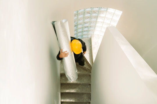 Worker using the stairs of a house in renovation