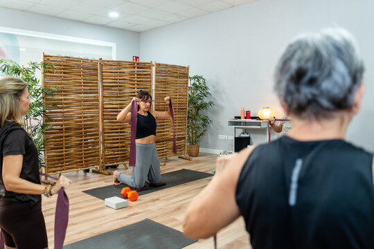Women training with resistance bands in pilates class