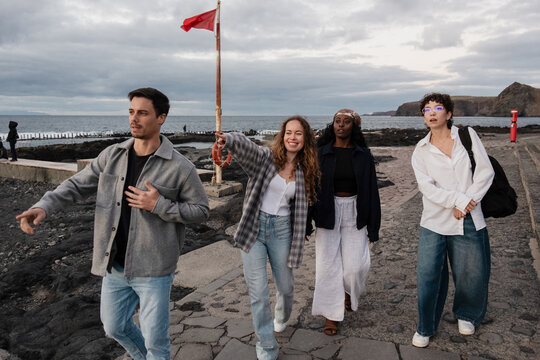 Group of tourists enjoying coastal walk at sunset