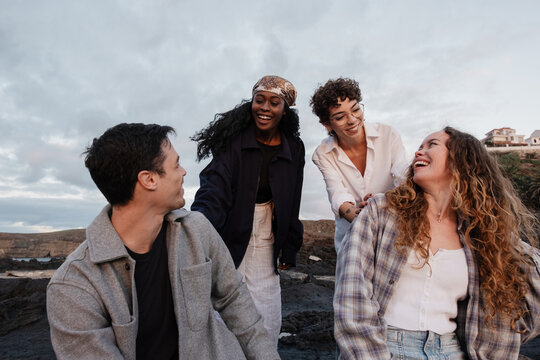Group of companions enjoying time together laughing outdoors
