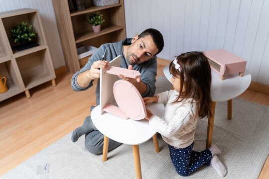 Father Assembling Furniture With Child